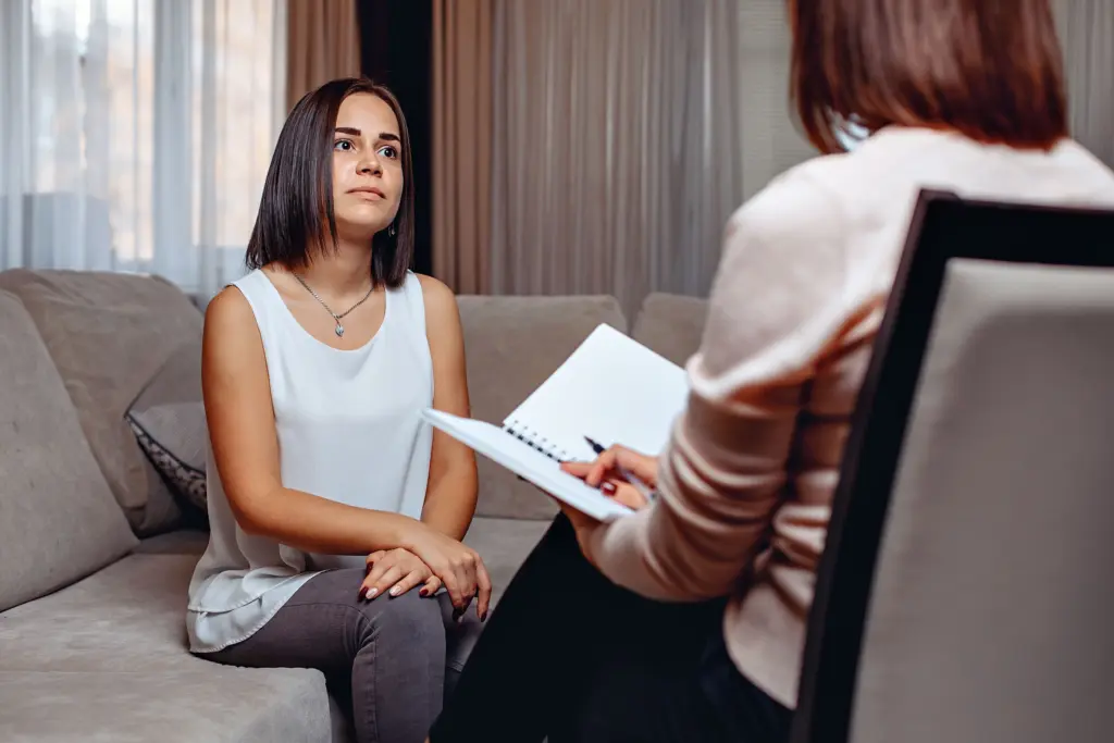 Beautiful worried woman at a psychologist appointment. Psychological problems. Mental problems concept