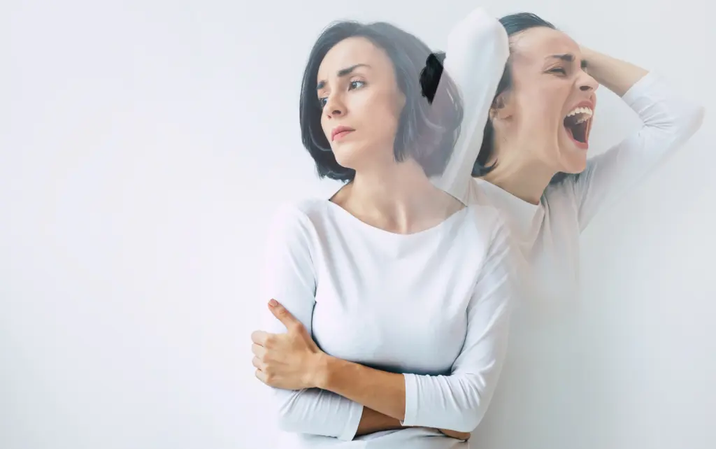 Schizophrenia. Close up photo of a young beautiful sad woman suffering from multiple personality disorders. Double exposure.